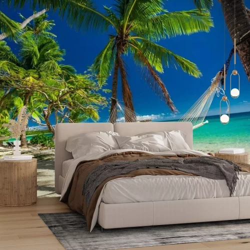 Fotobehang Hangmat aan palmbomen op het strand