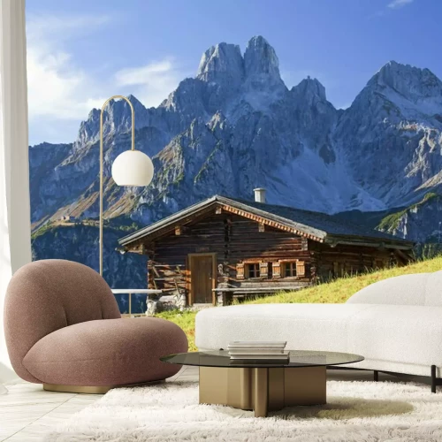 Fotobehang Hutje op een bergachtergrond