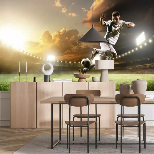 Fotobehang Een voetballer die de bal in het stadion schopt