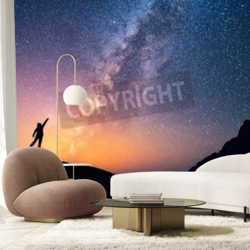 Fotobehang Een persoon die naar de sterren wijst