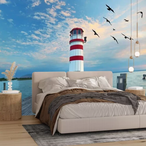 Fotobehang Zonsondergang bij de vuurtoren op het meer