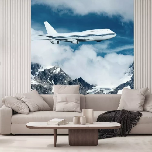 Fotobehang Een vliegtuig dat over besneeuwde bergen vliegt