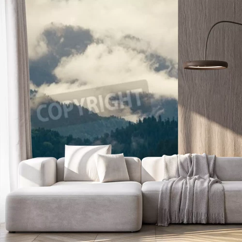 Fotobehang Wolken boven een bergwoud