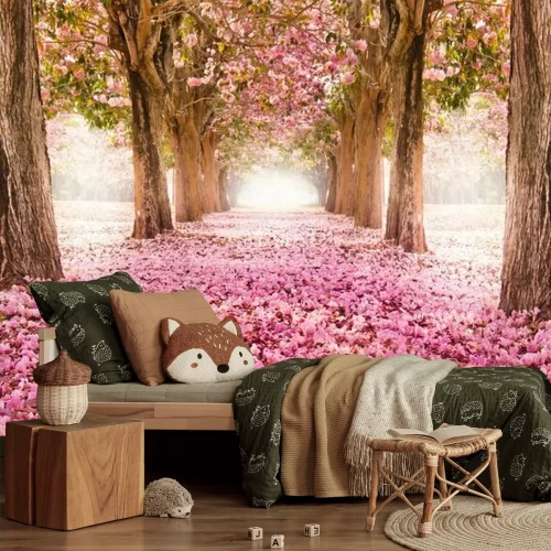 Fotobehang Een pad met roze bloemen tussen de bomen