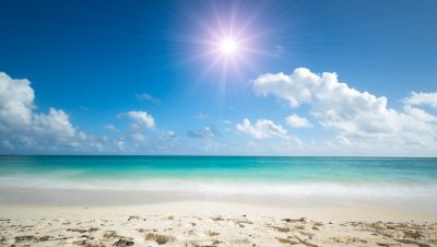 Fotobehang Strand en volle zon over de zee